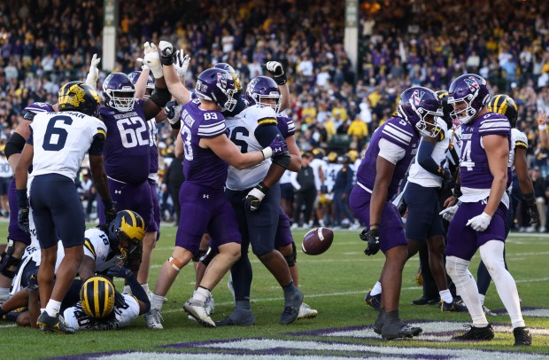 Northwestern running back Caleb Komolafe (5) drops the ball after crossing the end zone for a touchdown against Michigan in the fourth quarter at Wrigley Field on Nov. 15, 2025, in Chicago. (John J. Kim/Chicago Tribune)