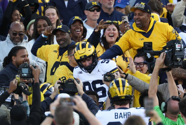 Michigan kicker Dominic Zvada is congratulated by fans after making a game-winning field goal for a 24-22 win over Northwestern at Wrigley Field on Nov. 15, 2025, in Chicago. (John J. Kim/Chicago Tribune)