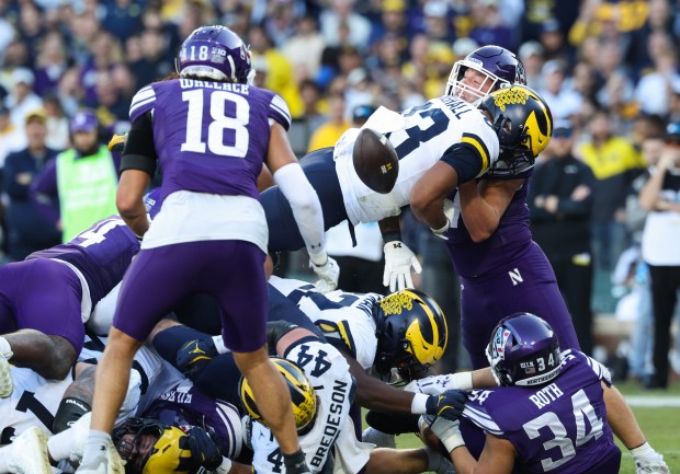 The ball pops loose after Michigan running back Jordan Marshall (23) crosses the end zone for a touchdown against Northwestern in the third quarter at Wrigley Field on Nov. 15, 2025, in Chicago. (John J. Kim/Chicago Tribune)