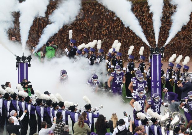 Northwestern players enter the field for a game against Michigan at Wrigley Field on Nov. 15, 2025, in Chicago. (John J. Kim/Chicago Tribune)