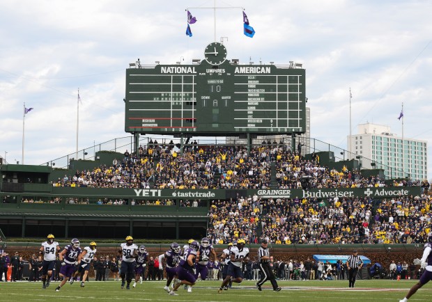 Michigan quarterback Bryce Underwood (19) keeps the ball for a rush in the first quarter against Northwestern at Wrigley Field on Nov. 15, 2025, in Chicago. (John J. Kim/Chicago Tribune)