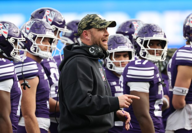 Northwestern head coach David Braun talks to players in the second quarter against Michigan at Wrigley Field on Nov. 15, 2025, in Chicago. (John J. Kim/Chicago Tribune)