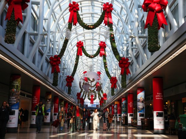 Travelers walk through a grandly decorated terminal at Chicago O'Hare International Airport on Dec. 3, 2024, in Chicago. (Stacey Wescott/Chicago Tribune)