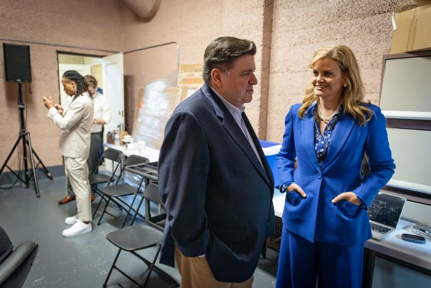 Illinois Gov. JB Pritzker and his wife, first lady MK Pritzker, wait backstage before he announced his candidacy for a third term, June 26, 2025, at the Grand Crossing Park field house in Chicago. (Brian Cassella/Chicago Tribune)