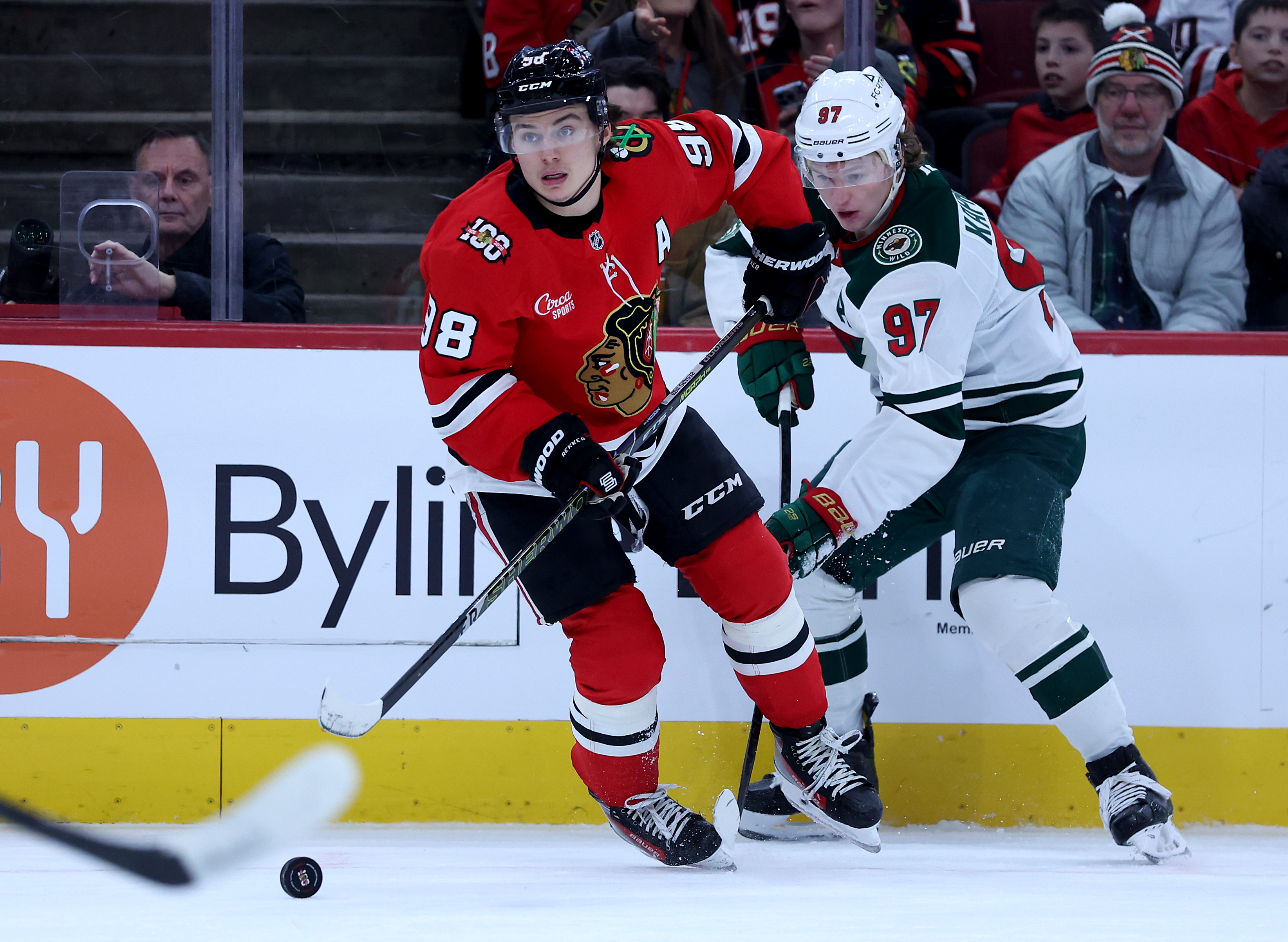Chicago Blackhawks center Connor Bedard (98) and Minnesota Wild left wing Kirill Kaprizov (97) battle in the first period of a game at the United Center in Chicago on Nov. 26, 2025. (Chris Sweda/Chicago Tribune)