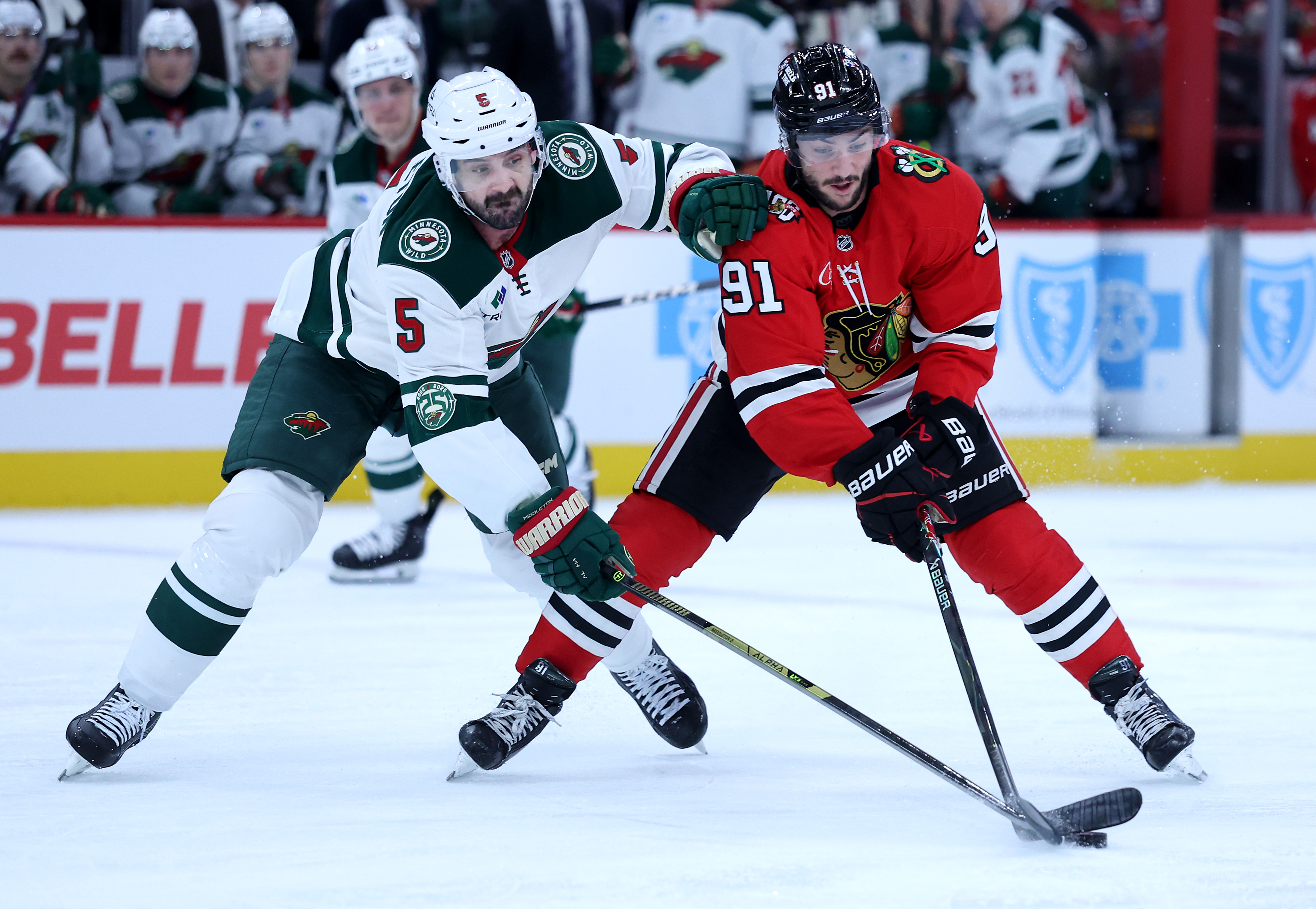 Minnesota Wild defenseman Jake Middleton (5) and Chicago Blackhawks center Frank Nazar (91) battle in the first period of a game at the United Center in Chicago on Nov. 26, 2025. (Chris Sweda/Chicago Tribune)