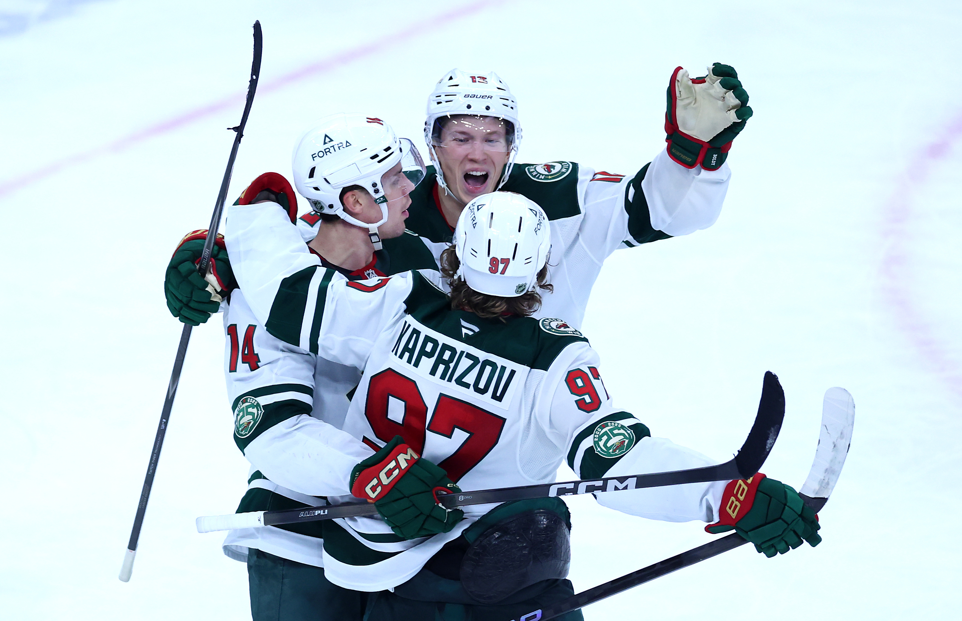 Minnesota Wild left wing Kirill Kaprizov (97) is congratulated by his teammates after scoring the winning goal in overtime of a game against the Chicago Blackhawks at the United Center in Chicago on Nov. 26, 2025. (Chris Sweda/Chicago Tribune)