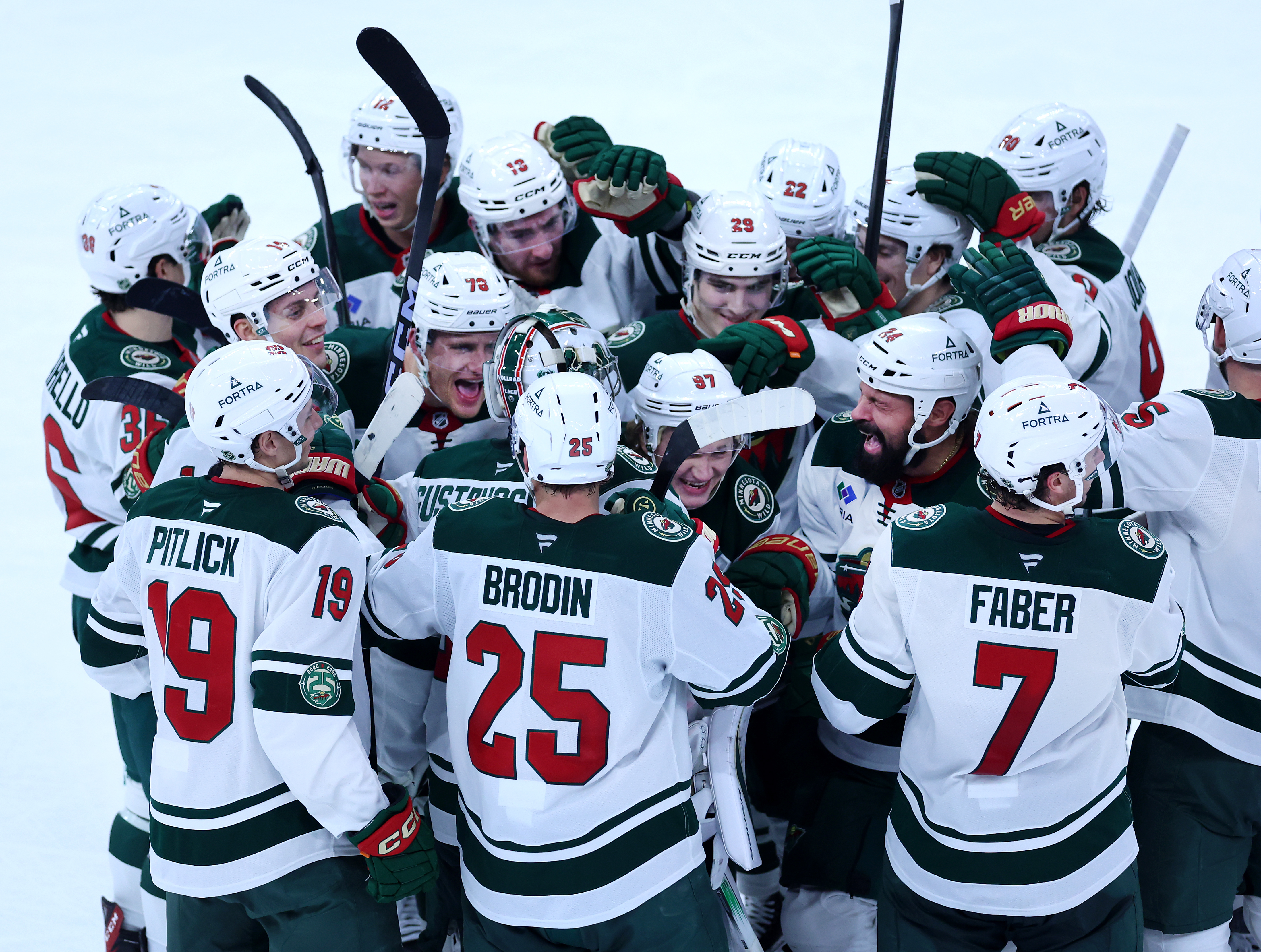 Minnesota Wild left wing Kirill Kaprizov (97) is congratulated by his teammates after scoring the winning goal in overtime of a game against the Chicago Blackhawks at the United Center in Chicago on Nov. 26, 2025. (Chris Sweda/Chicago Tribune)