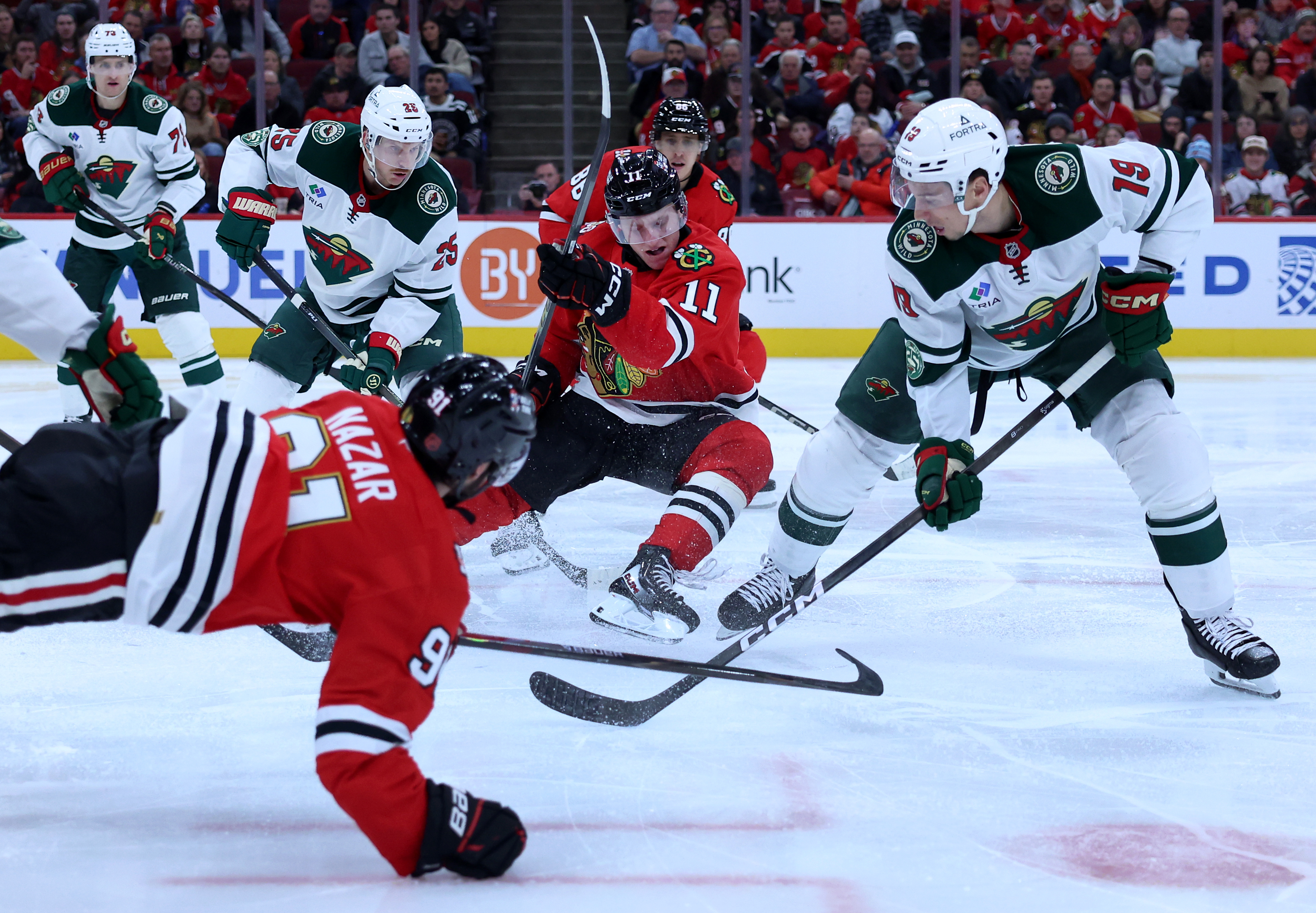 Chicago Blackhawks center Oliver Moore (11) tries to make a play in the third period of a game against the Minnesota Wild at the United Center in Chicago on Nov. 26, 2025. (Chris Sweda/Chicago Tribune)