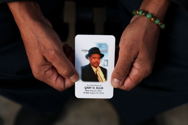 Gary Brown sits on a bench outside his father's former apartment building near the corner of South Michigan Avenue and East 13th Street in the South Loop on Oct. 20, 2025. Brown's father, Gary Ellis, a former CTA bus driver, enjoyed sitting on the bench and watching the activity near the bus stop outside of his apartment. (Eileen T. Meslar/Chicago Tribune)