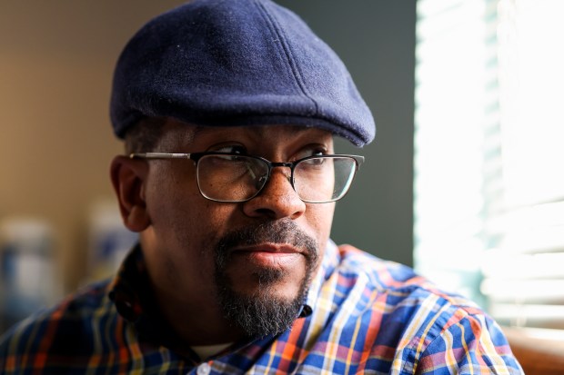 Derrell Collier looks out the window of his mother's room while visiting her in a nursing home in Chicago on Oct. 28, 2025. "She took care of everyone in the family. I think it's only right. It's her turn." (Eileen T. Meslar/Chicago Tribune) 