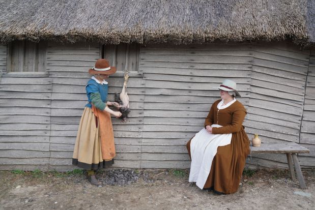 Re-enactors pluck a bird in the English Village at the Plimoth Patuxet Museums on Thanksgiving Day, Nov. 25, 2021, in Plymouth, Massachusetts. (Bryan R. Smith/Getty-AFP)