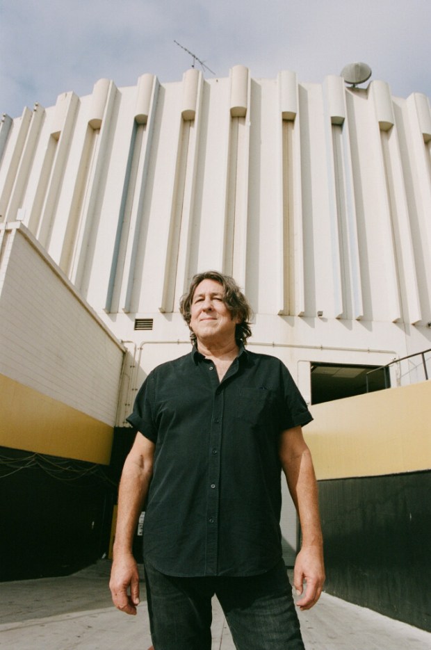 Cameron Crowe outside Pechanga Arena, where a key scene from his movie "Almost Famous" takes place, in San Diego, Aug. 24, 2022. Crowe adapted his Oscar-winning screenplay, about writing for Rolling Stone in the '70s, preserving parts of the movie's soundtrack and zingers (Don't take drugs!) for the stage. (Magdalena Wosinska/The New York Times)