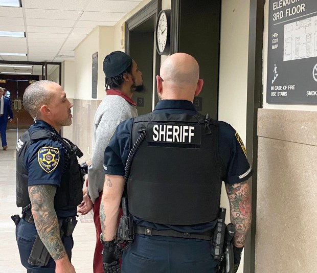 Robert Cooper III is escorted by sheriff's deputies from a Montgomery County courtroom to begin serving a prison term for his role in a gun trafficking network. (Photo by Carl Hessler Jr. - MediaNews Group)