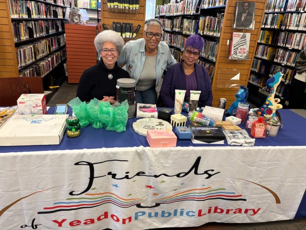 Friends of the Yeadon Public Library members, from left, Elaine Wormley, Denise Stinson and Doris Wilson staff a booth at the Black Saturday Extravaganza. (KATHLEEN E. CAREY - DAILY TIMES)
