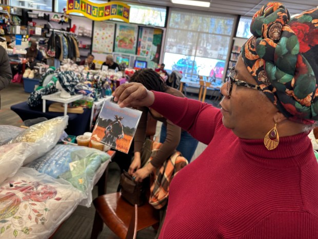 Renee Lucas Wayne, aka Sister Scribe, shows her CD, "Daughter of Zion," which she was selling along with her Sister Love Perfect Pillows at the Black Saturday Extragavanza. (KATHLEEN E. CAREY - DAILY TIMES)