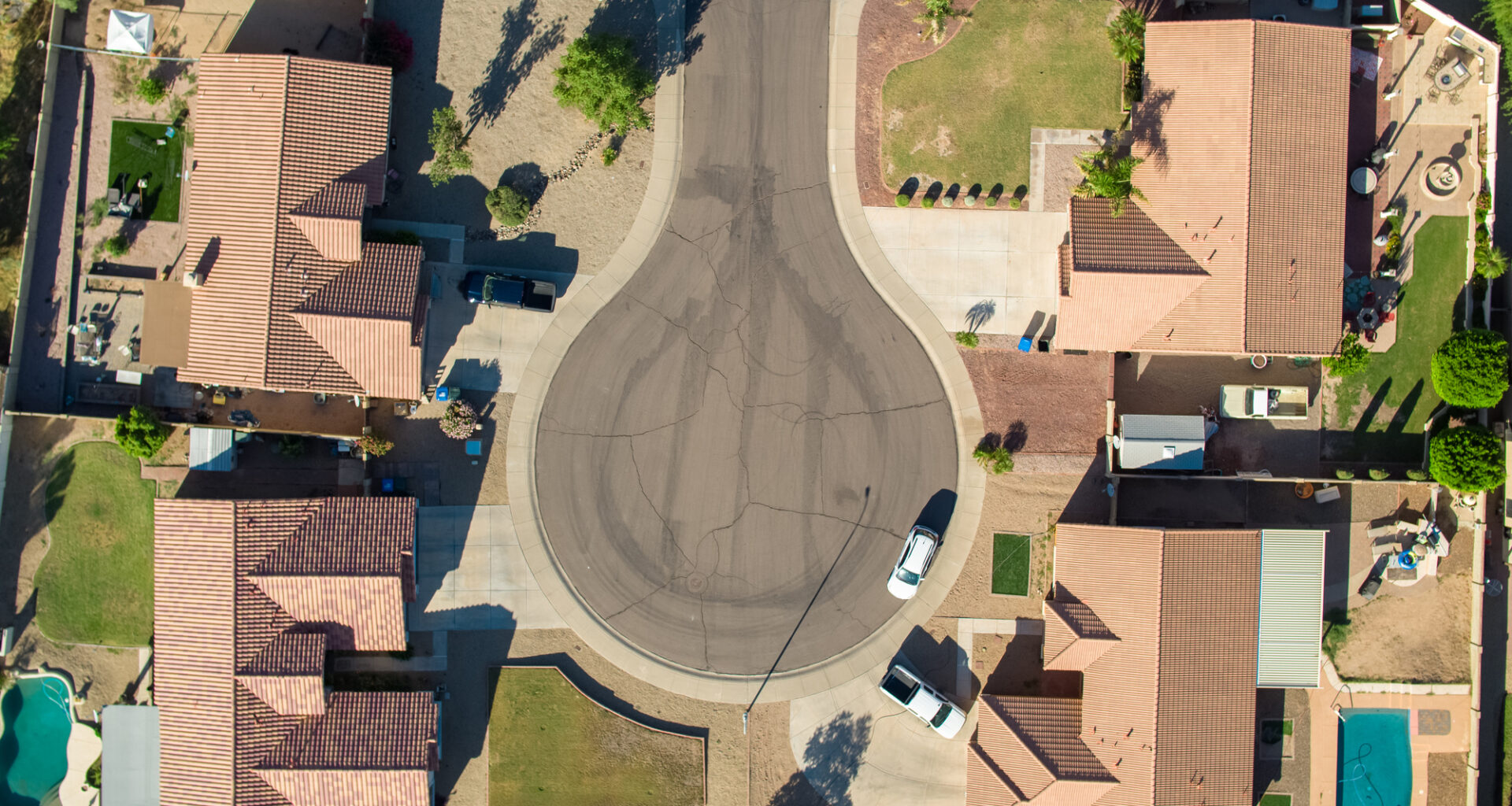 a drone shot taken above four houses on a cul-de-sac in Phoenix