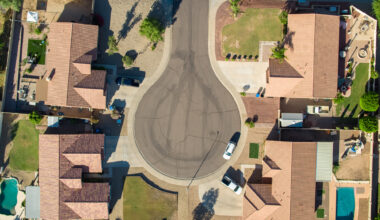 a drone shot taken above four houses on a cul-de-sac in Phoenix