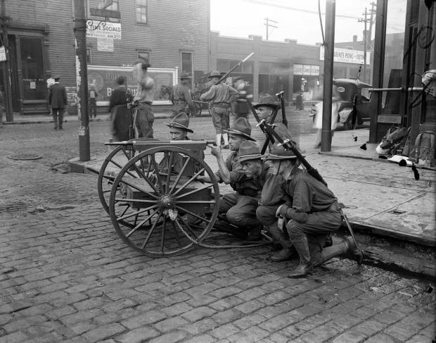 Members of the state militia hold their ground at 47th...