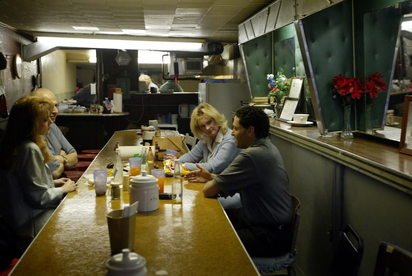 Janet Leal (from left), Larry Leal, Barbara Horn, and Nader Ayoub enjoy hamburgers at Rose's...