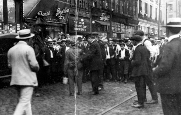 A Black man is searched by Chicago police in front...
