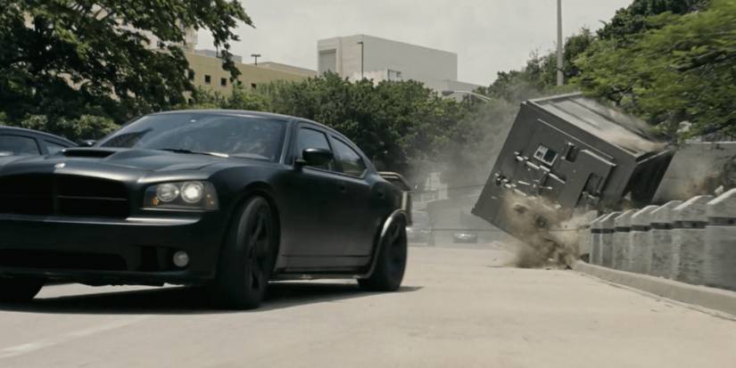 A car drags a safe during a heist in Fast Five
