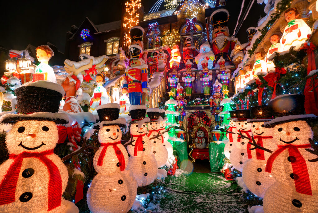 Image shows a heavily decorated for the holidays including a pathway of snowmen, nutcrackers, and lights.