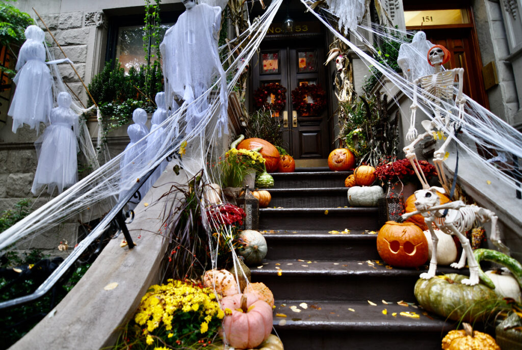 Image shows a porch of a home in Halloween decorations.