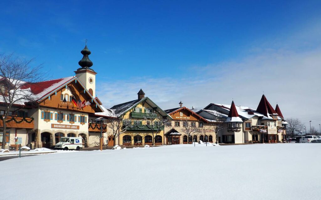 Bavarian-style houses of the Bavarian Inn center on a perfect winter day. Blue sky above and white snow on the ground. No people. Simply beautiful.