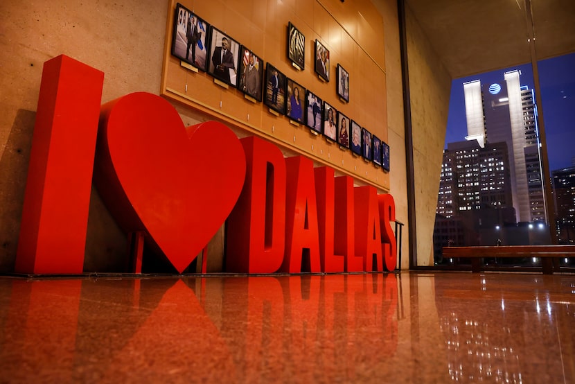 An ‘I Love Dallas’ sculpted sign stands in Dallas City Hall before the skyline which...