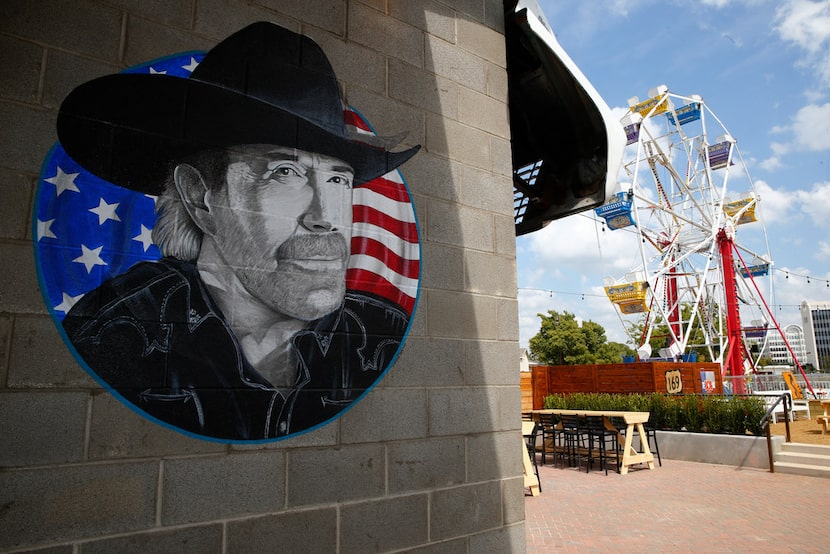 Entering the backyard at Ferris Wheelers in Dallas, customers pass a painting of Chuck...