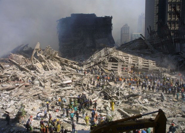 Rescue workers sift through the wreckage of the World Trade Center September 13, 2001 in New York City, two days after two hijacked airplanes slammed into the twin towers, levelling them in an alleged terrorist attack. (Photo by Mario Tama/Getty Images)