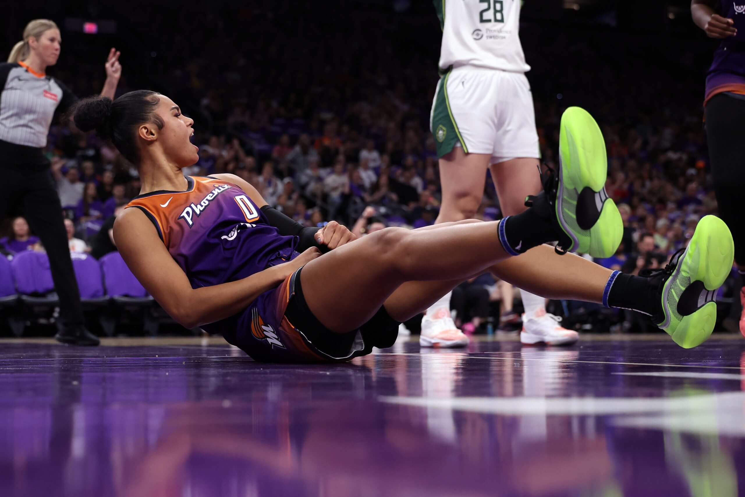 Satou Sabally falls to the court.