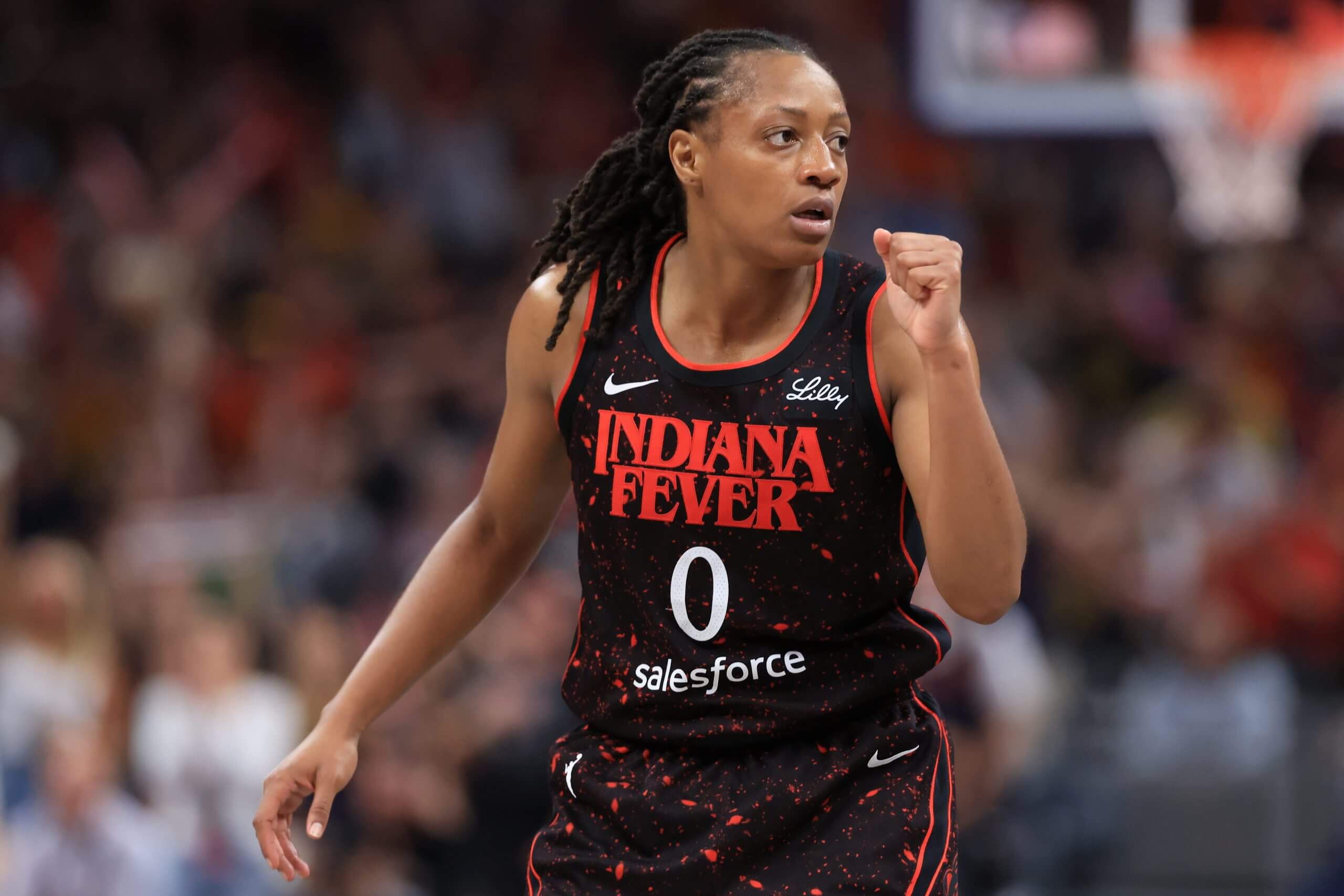Indiana Fever guard Kelsey Mitchell pumps her fist to celebrate a play. 