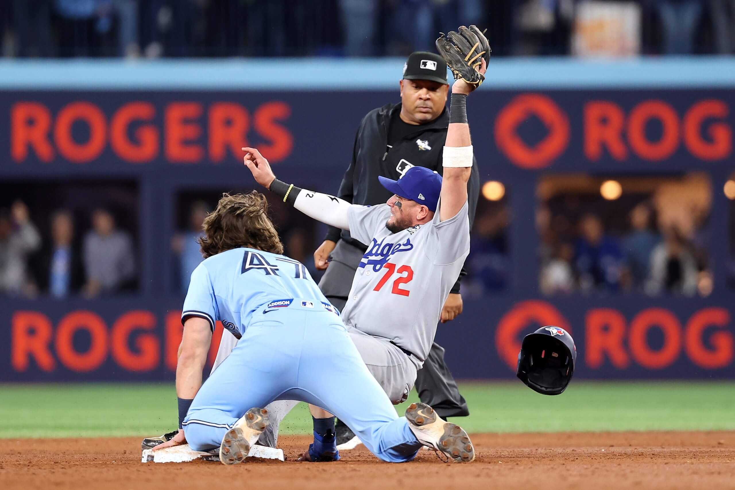 TORONTO, ONTARIO - OCTOBER 31: Miguel Rojas #72 of the Los Angeles Dodgers forces out Addison Barger #47 of the Toronto Blue Jays to win the game 3-1 in game six of the 2025 World Series at Rogers Center on October 31, 2025 in Toronto, Ontario. 