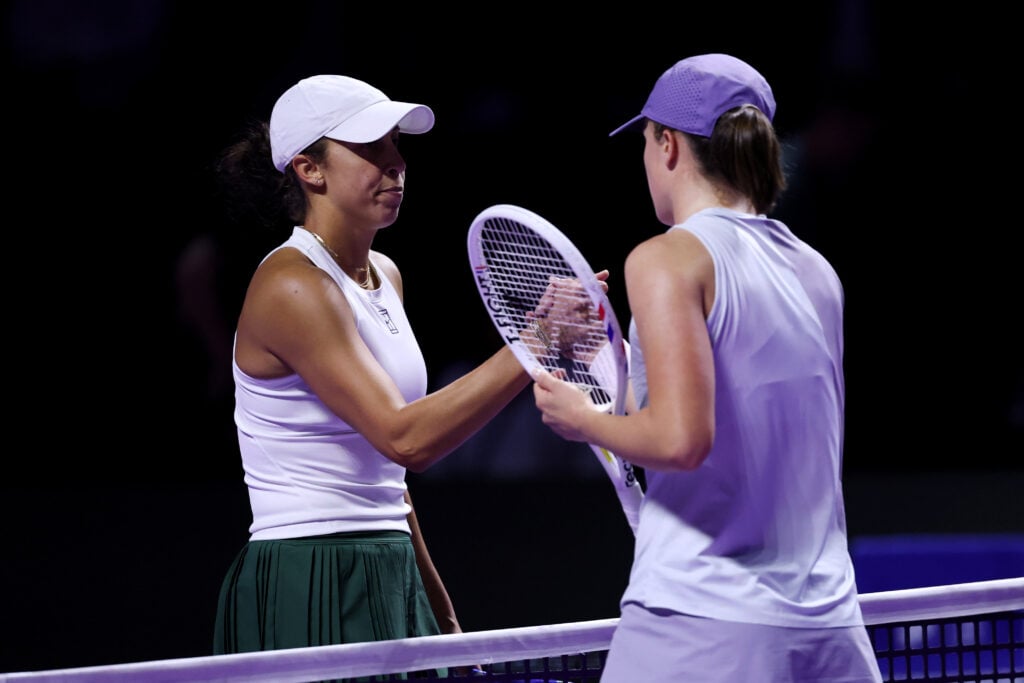 Iga Swiatek and Madison Keys shake hands after their match at the 2025 WTA Finals