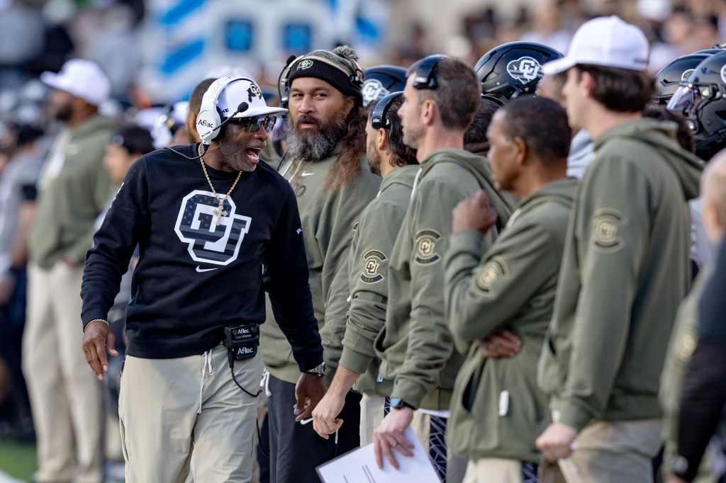 Deion Sanders (l.) on the sideline during Colorado's loss to Arizona on Nov. 1, 2025.
