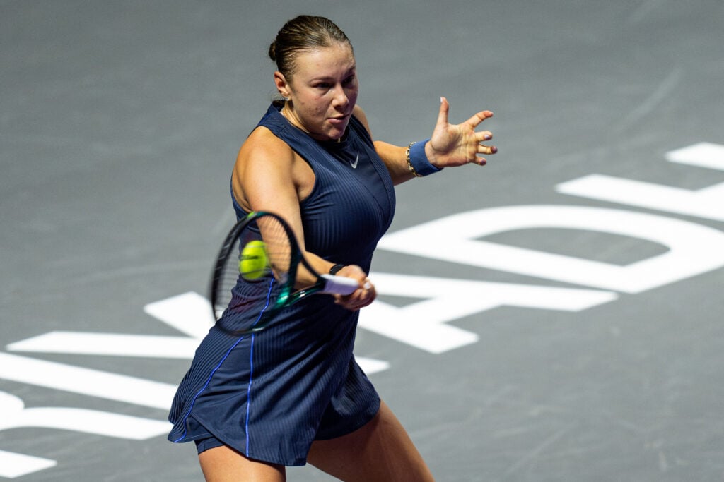 Amanda Anisimova hits a forehand against Iga Swiatek at the 2025 WTA Finals