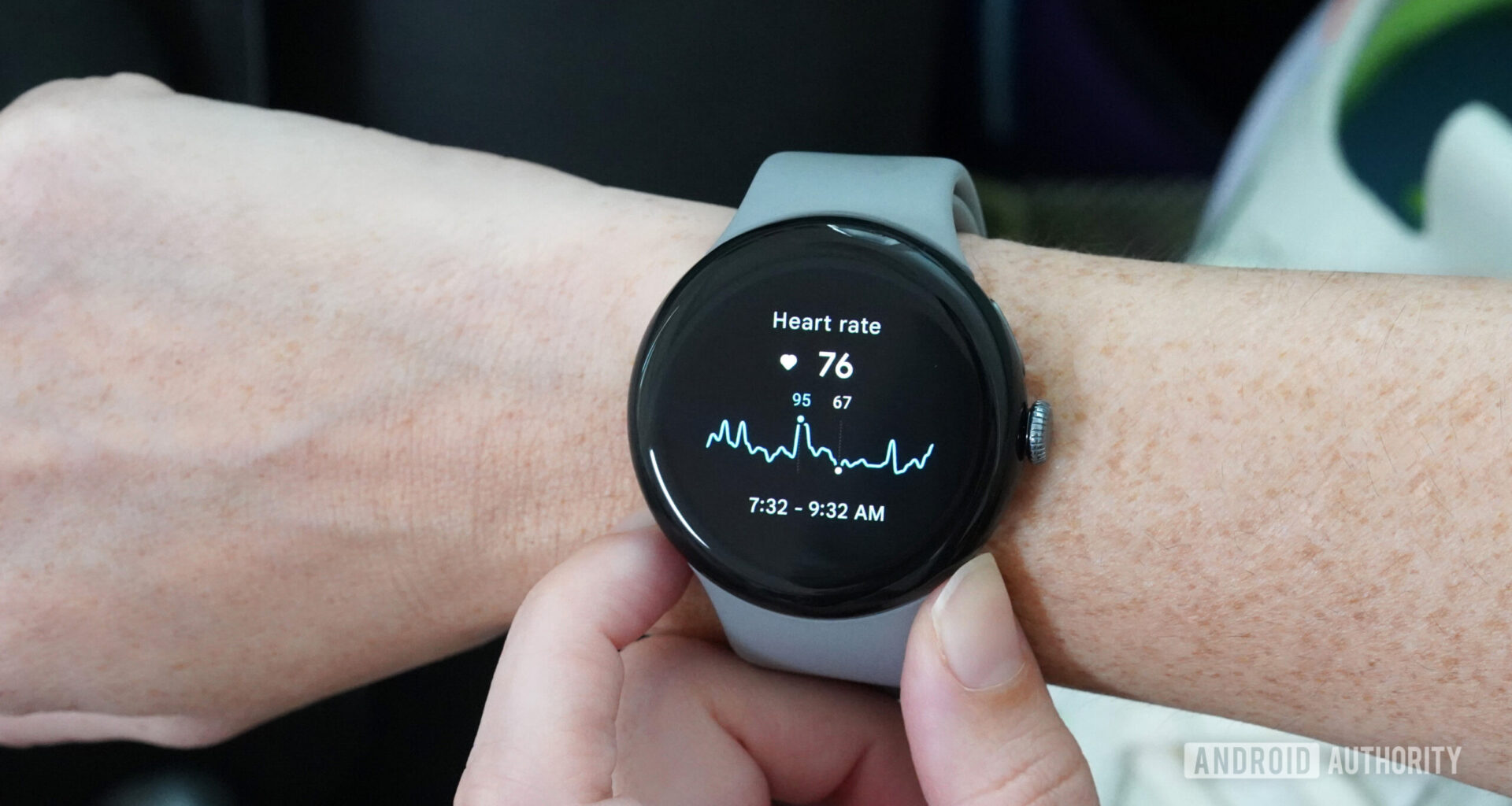 A Google Pixel Watch 3 on a user's wrists displays their heart rate data.