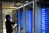 This file photo taken on July 21, 2014, shows an employee of Equinix data center checking...