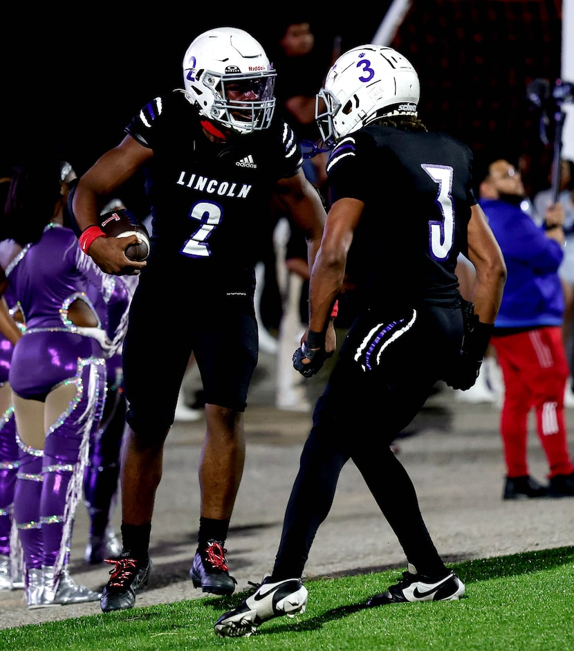 Lincoln running back Jastin Hampton (2) celebrates with wide receiver Okeith Robinson (3)...
