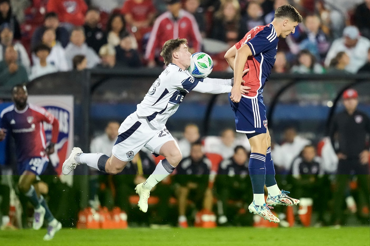FC Dallas forward Logan Farrington (right) challenges Vancouver Whitecaps defender Tate...