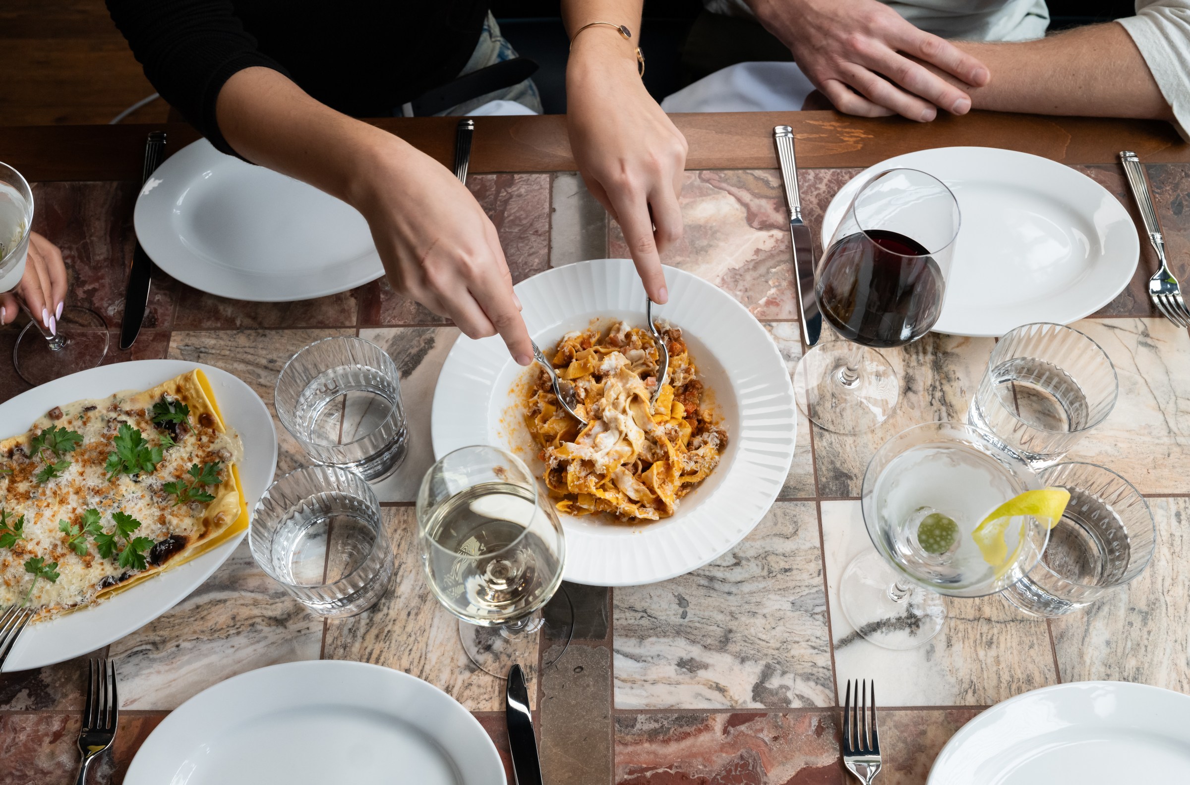 Overhead shot of Bolognese and lasagna at Hermon’s