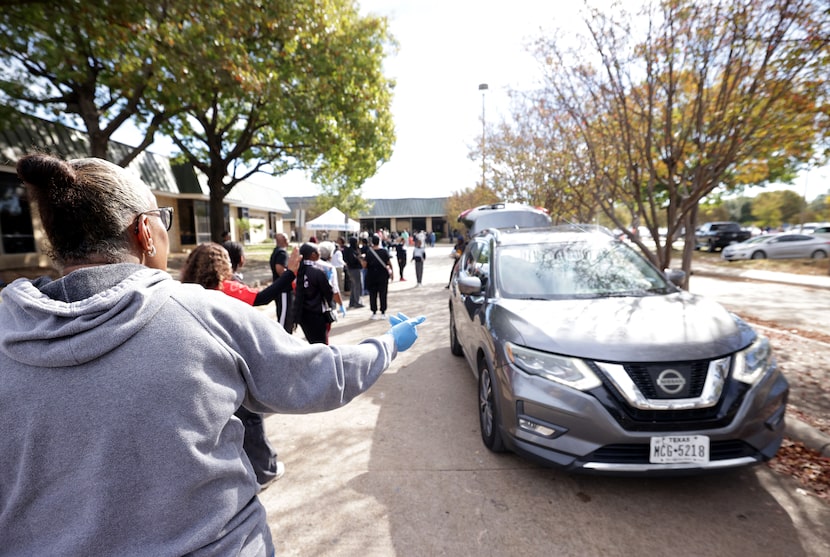 Cars line up during the Feed the Streetz Outreach annual Thanksgiving Blessing food...