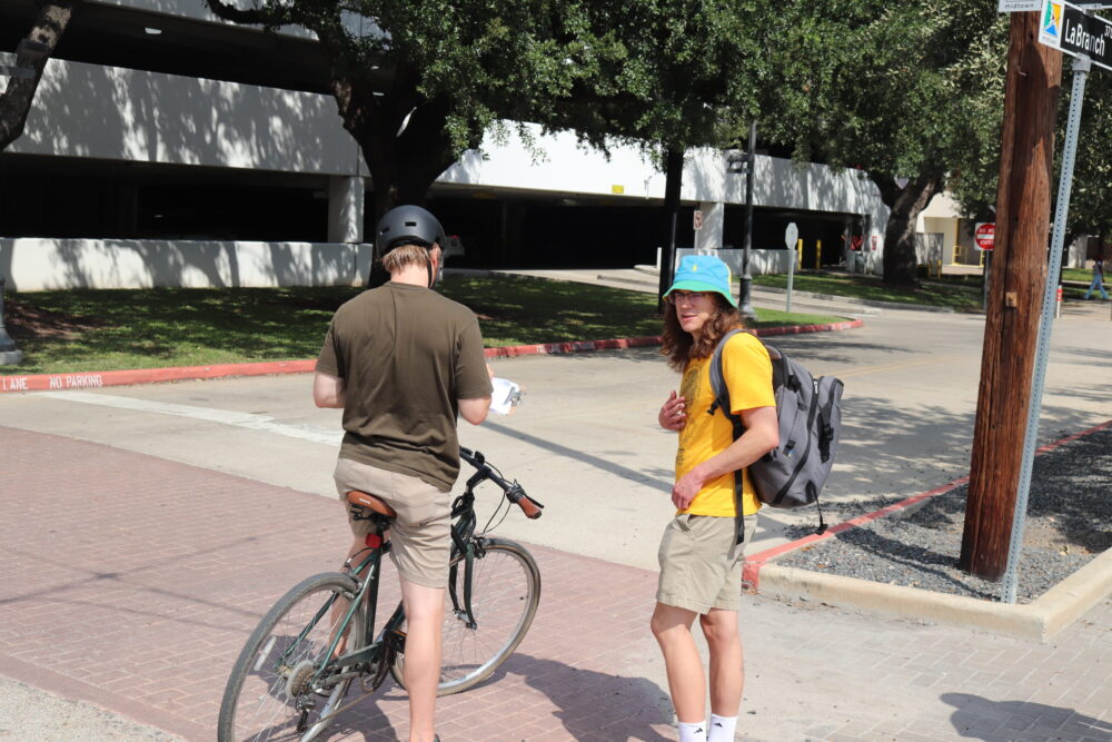 Ethan Hale (right) collects signatures for a petition to recall Houston Mayor John Whitmire. Oct. 6, 2025.