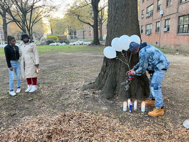 Residents of NYCHA's Bayview Houses set up a memorial where a infant boy's body was found on Thursday, Nov. 20, 2025. (Julian Roberts-Grmela / New York Daily News)