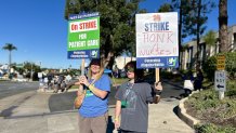 Rebecca Stewart on strike Friday with support from her son, Teddy, 11, November 28, 2025.