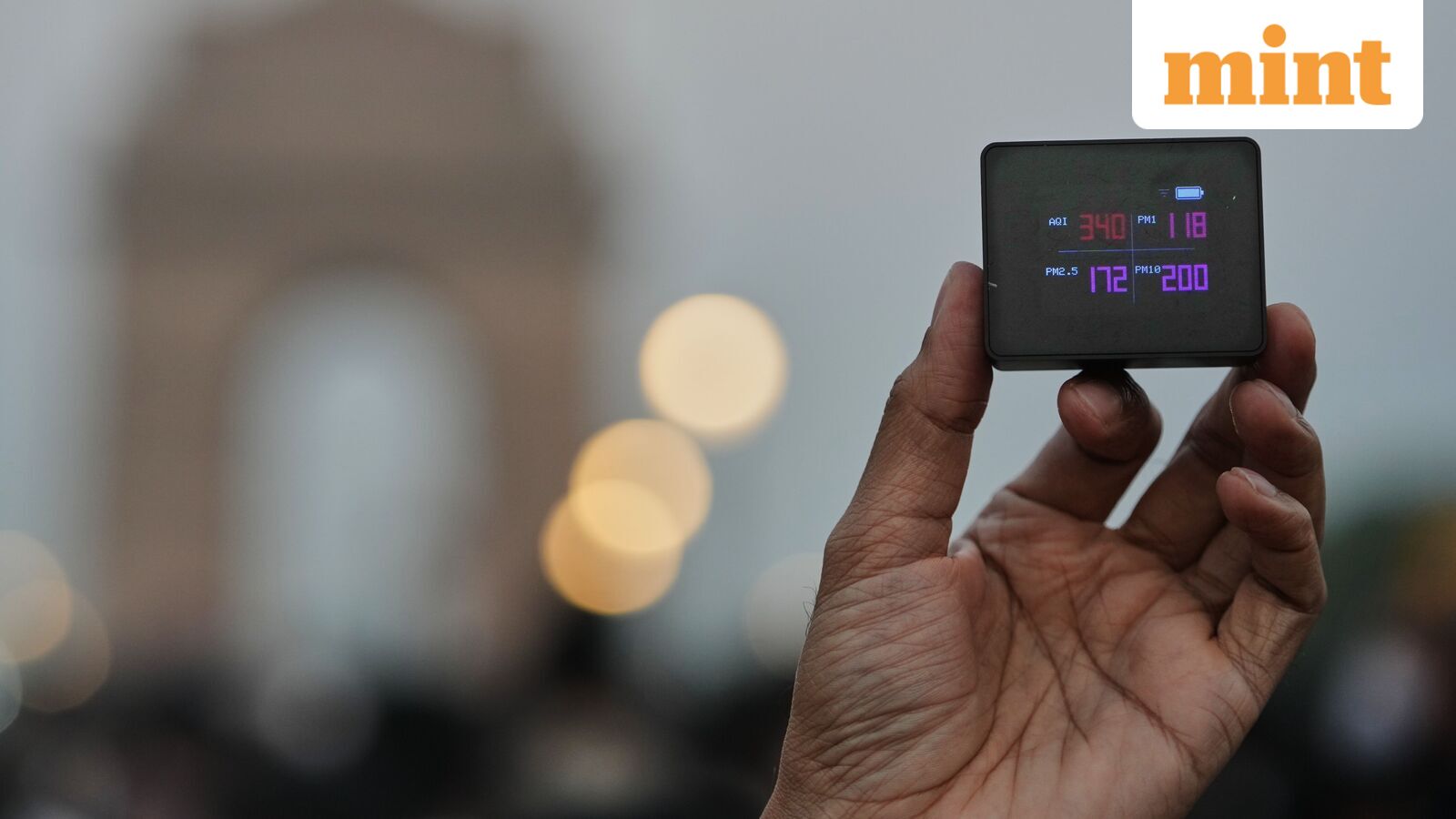 A protester shows the present AQI or Air Quality Index during a protest against what they called the government's lack of action to combat air pollution in the capital city New Delhi, India, Sunday, Nov. 9, 2025. (AP Photo/Manish Swarup)