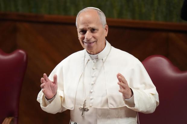 Pope Leo XIV gestures as he arrives at the Pontifical Lateran University on the occasion of the opening of the academic year, in Rome, Friday, Nov. 14, 2025. (AP Photo/Alessandra Tarantino)