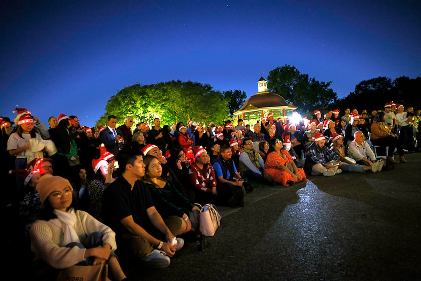Visitors listen as Members of the Turtle Creek Chorale sing during “ Holiday at the...
